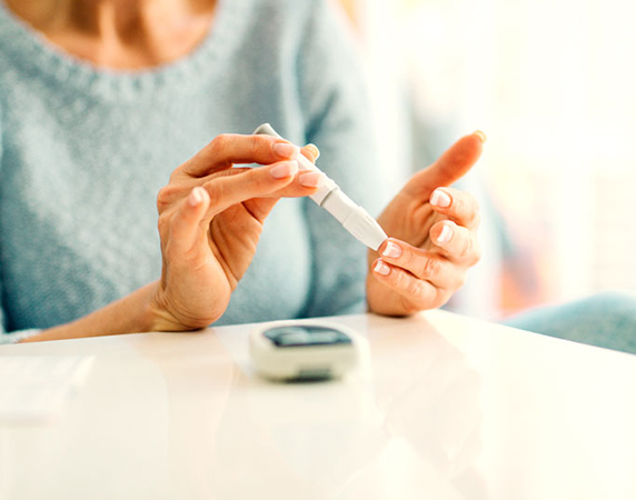 Woman with diabetes checking her blood sugar