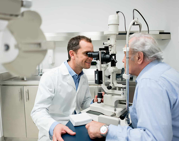 Eye doctor performing eye exam on patient