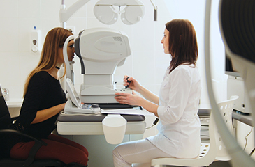 Patient receiving eye exam from eye doctor